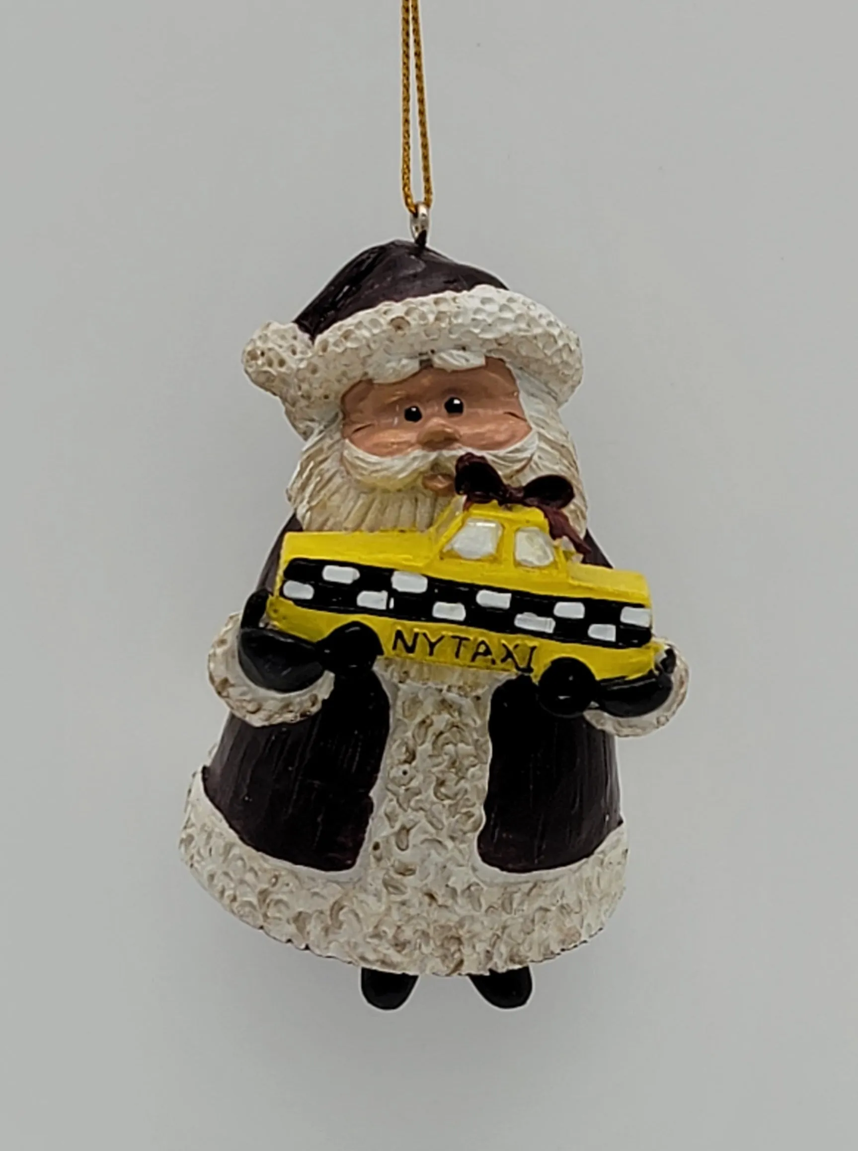 Santa holding a Yellow Cap NYC Taxi Christmas ornament